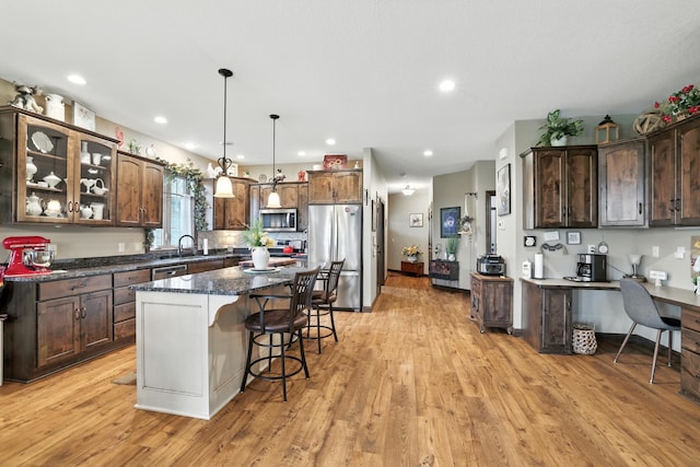129 Highland Cir, Dassel, MN 55325 - kitchen featuring stainless steel appliances, a kitchen breakfast bar, light wood-style flooring, a kitchen island, and recessed lighting