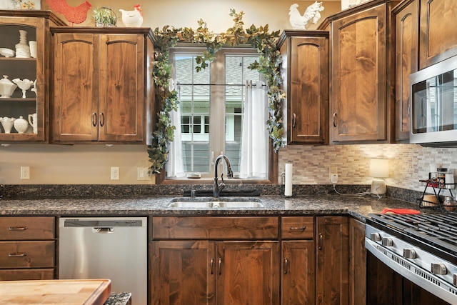 129 Highland Cir, Dassel, MN 55325 - kitchen featuring stainless steel appliances, dark stone countertops, glass insert cabinets, and tasteful backsplash