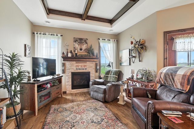 129 Highland Cir, Dassel, MN 55325 - living area with plenty of natural light, coffered ceiling, beamed ceiling, a glass covered fireplace, and wood finished floors
