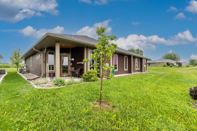 129 Highland Cir, Dassel, MN 55325 - back of property featuring a patio and a lawn