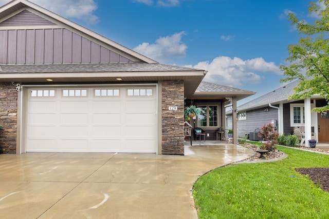 129 Highland Cir, Dassel, MN 55325 - view of front of property featuring stone siding, concrete driveway, board and batten siding, roof with shingles, and a garage