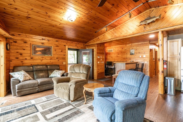 2913 125th St, Island Lake Twp, MN 56651 - living room featuring vaulted ceiling, wood finished floors, wood walls, track lighting, and wooden ceiling