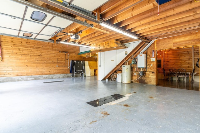2913 125th St, Island Lake Twp, MN 56651 - garage with a garage door opener, wooden walls, tankless water heater, and electric water heater