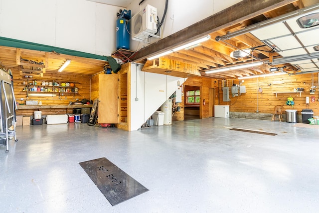 2913 125th St, Island Lake Twp, MN 56651 - garage featuring wood walls, a workshop area, electric panel, and a garage door opener