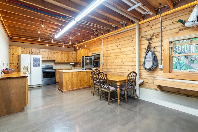 2913 125th St, Island Lake Twp, MN 56651 - dining area featuring concrete floors and wood walls