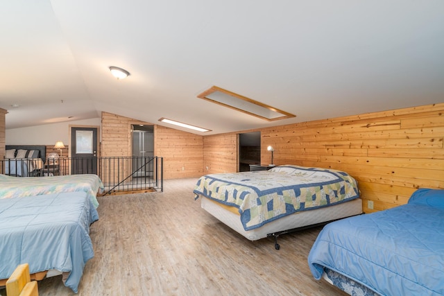 2913 125th St, Island Lake Twp, MN 56651 - bedroom with wooden walls, lofted ceiling, wood finished floors, and attic access