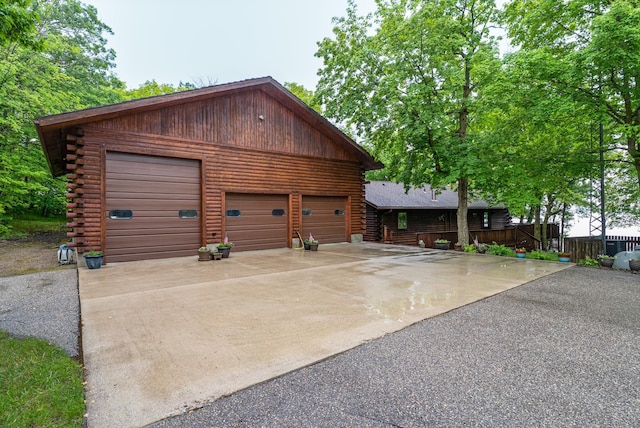 2913 125th St, Island Lake Twp, MN 56651 - view of front facade featuring log siding and a garage