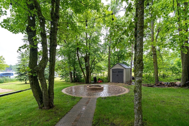 2913 125th St, Island Lake Twp, MN 56651 - view of green lawn with a fire pit and a shed