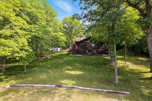2913 125th St, Island Lake Twp, MN 56651 - view of grassy yard featuring a deck, a storage unit, and stairway
