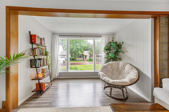 211 Viola St, Mankato, MN 56001 - living area with wood finished floors, crown molding, and wood walls