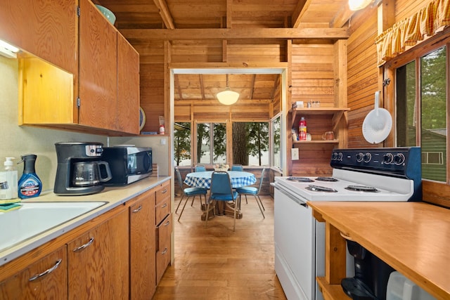 14354 Chippewa Loop, Park Rapids, MN 56470 - kitchen with electric range, stainless steel microwave, wood walls, a wood ceiling with exposed beams, and light countertops