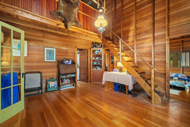 14354 Chippewa Loop, Park Rapids, MN 56470 - living room with wood walls, stairs, hardwood / wood-style flooring, and a high ceiling