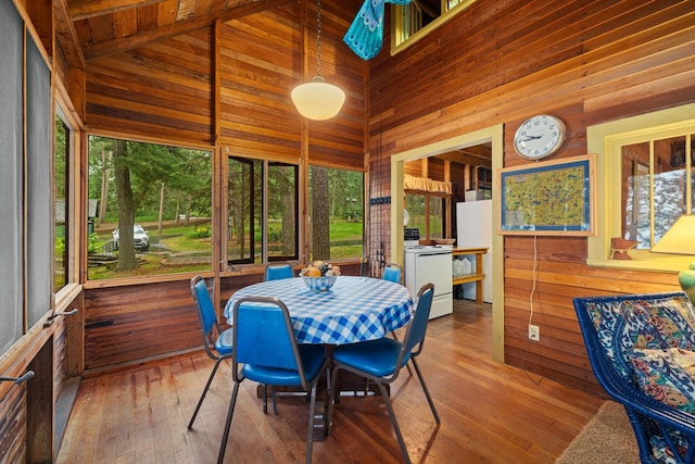 14354 Chippewa Loop, Park Rapids, MN 56470 - sunroom / solarium with wooden walls, high vaulted ceiling, hardwood / wood-style floors, a wooden deck, and outdoor dining space