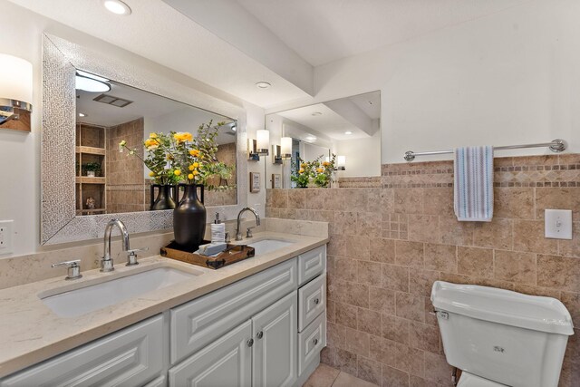8473 Kentucky Ct N, Brooklyn Park, MN 55445 - bathroom with tile walls, double vanity, tile patterned flooring, and recessed lighting