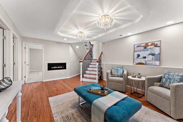 8473 Kentucky Ct N, Brooklyn Park, MN 55445 - living area featuring recessed lighting, a chandelier, a raised ceiling, wood finished floors, and stairway