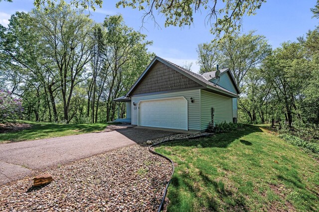 13838 Glendale Trl, Savage, MN 55378 - view of side of home featuring a lawn, asphalt driveway, and an attached garage