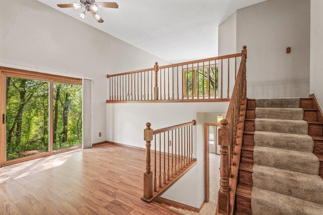 13838 Glendale Trl, Savage, MN 55378 - staircase featuring high vaulted ceiling, wood finished floors, and ceiling fan