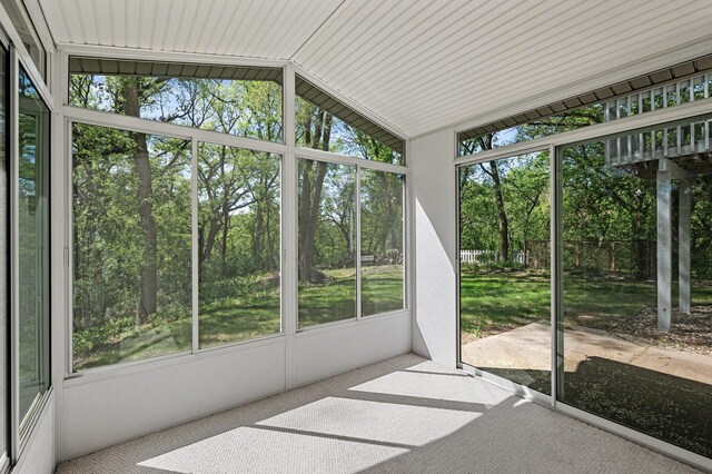 13838 Glendale Trl, Savage, MN 55378 - unfurnished sunroom featuring plenty of natural light, lofted ceiling, and view of scattered trees