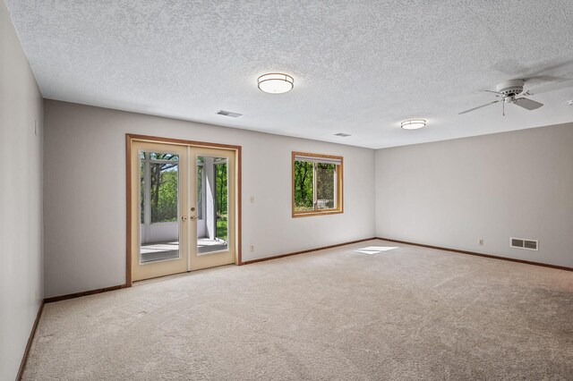 13838 Glendale Trl, Savage, MN 55378 - empty room with carpet flooring, ceiling fan, french doors, and a textured ceiling