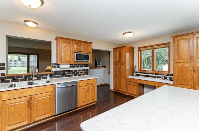 3714 8th St NW, Rochester, MN 55901 - kitchen featuring stainless steel appliances, light countertops, healthy amount of natural light, backsplash, and a textured ceiling