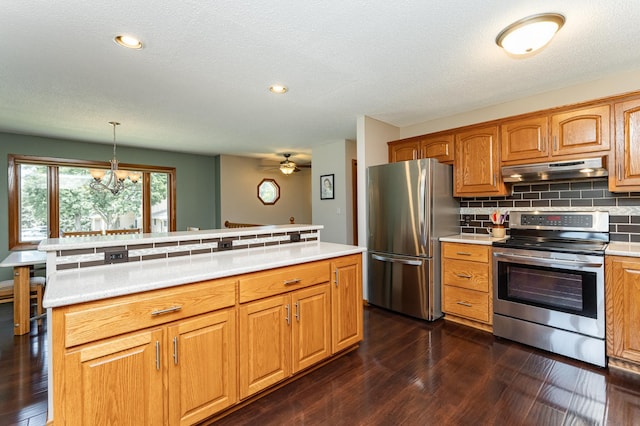 3714 8th St NW, Rochester, MN 55901 - kitchen featuring appliances with stainless steel finishes, under cabinet range hood, backsplash, light countertops, and dark wood finished floors