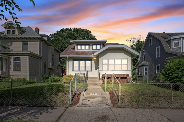 3736 Park Ave, Minneapolis, MN 55407 - view of front of property featuring stucco siding and a fenced front yard