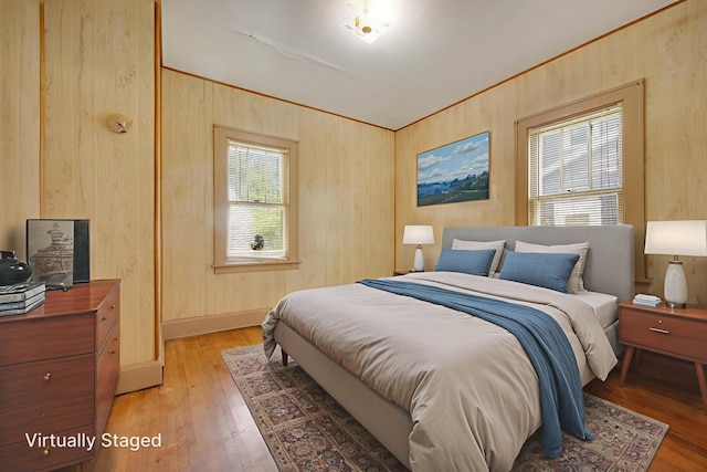 3736 Park Ave, Minneapolis, MN 55407 - bedroom featuring light wood-style flooring and wood walls