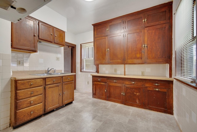 3736 Park Ave, Minneapolis, MN 55407 - kitchen with tile walls, light countertops, decorative backsplash, and brown cabinetry