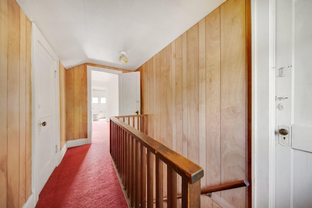 3736 Park Ave, Minneapolis, MN 55407 - corridor featuring an upstairs landing, carpet, lofted ceiling, and wood walls