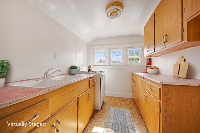 3736 Park Ave, Minneapolis, MN 55407 - kitchen featuring light countertops, lofted ceiling, white range with gas stovetop, and brown cabinetry