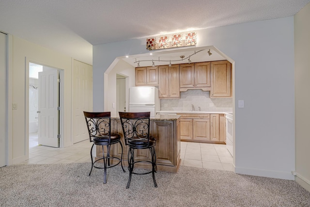 10521 Cedar Lake Rd Unit 208, Minnetonka, MN 55305 - kitchen featuring freestanding refrigerator, light tile patterned floors, and light carpet