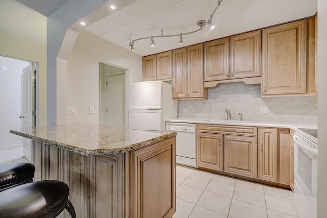 10521 Cedar Lake Rd Unit 208, Minnetonka, MN 55305 - kitchen featuring white appliances, a breakfast bar area, backsplash, light tile patterned floors, and light stone countertops