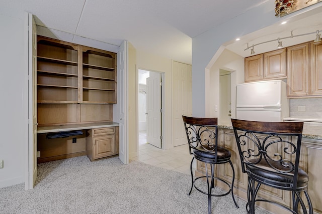 10521 Cedar Lake Rd Unit 208, Minnetonka, MN 55305 - kitchen featuring white fridge, light colored carpet, light countertops, backsplash, and arched walkways