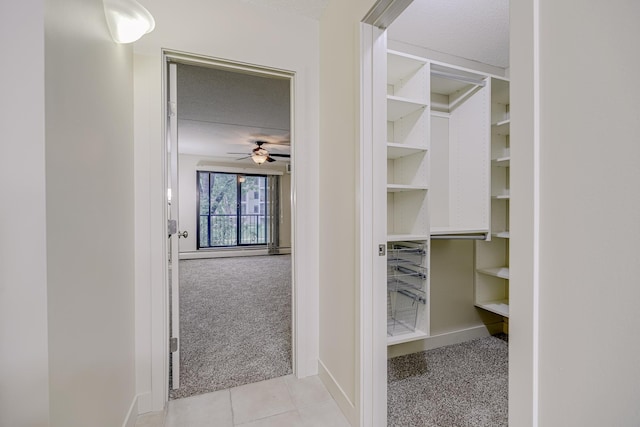 10521 Cedar Lake Rd Unit 208, Minnetonka, MN 55305 - walk in closet with ceiling fan, carpet flooring, and tile patterned floors