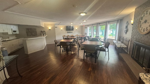 10521 Cedar Lake Rd Unit 208, Minnetonka, MN 55305 - dining area featuring dark wood finished floors and a textured ceiling
