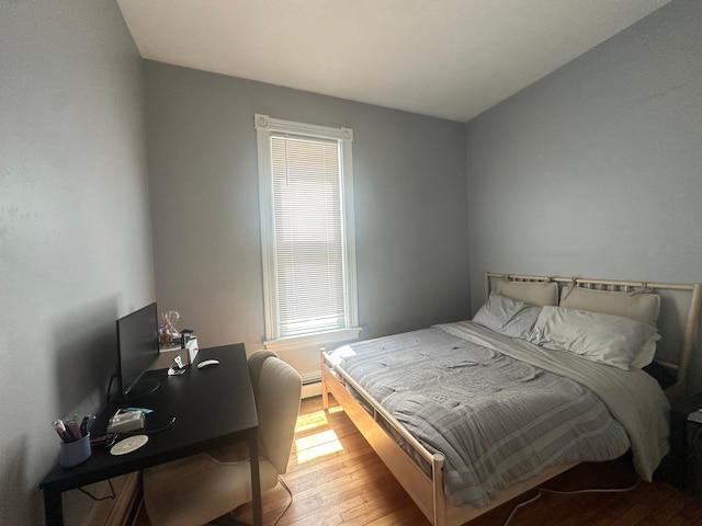 713 2nd St NE, Minneapolis, MN 55413 - bedroom featuring hardwood / wood-style flooring, baseboard heating, and an office area