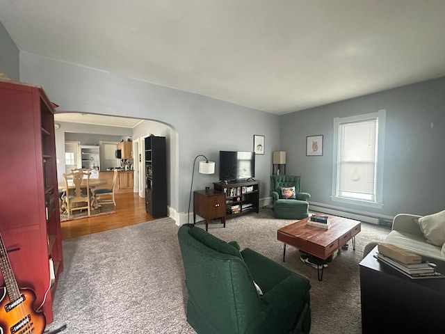 713 2nd St NE, Minneapolis, MN 55413 - carpeted living room featuring arched walkways and a baseboard heating unit