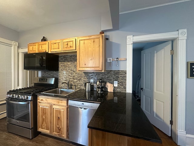 713 2nd St NE, Minneapolis, MN 55413 - kitchen featuring stainless steel appliances, dark countertops, tasteful backsplash, and dark wood-type flooring