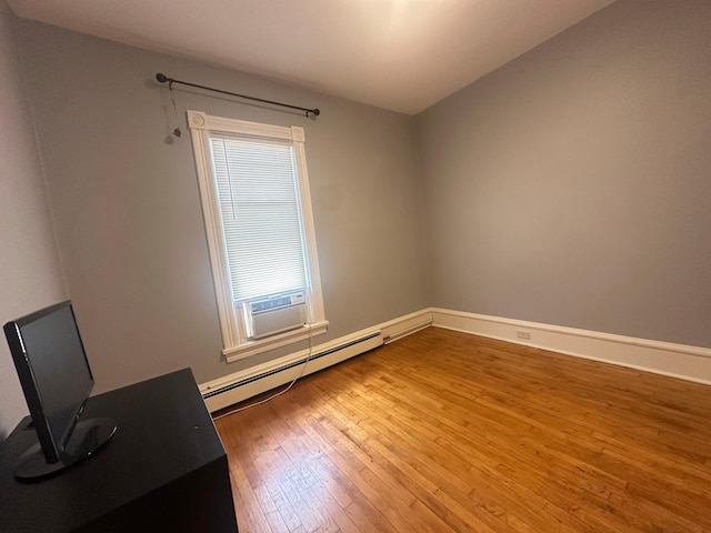 713 2nd St NE, Minneapolis, MN 55413 - unfurnished room with a baseboard heating unit, hardwood / wood-style floors, and cooling unit