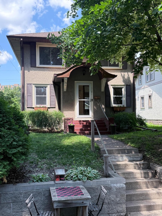 1141 Palace Ave, Saint Paul, MN 55105 - view of front of property featuring stucco siding, entry steps, and a front yard