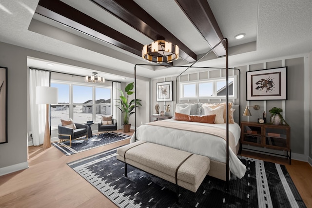 1162 Woods Creek Dr, Delano, MN 55328 - bedroom with a chandelier and wood finished floors