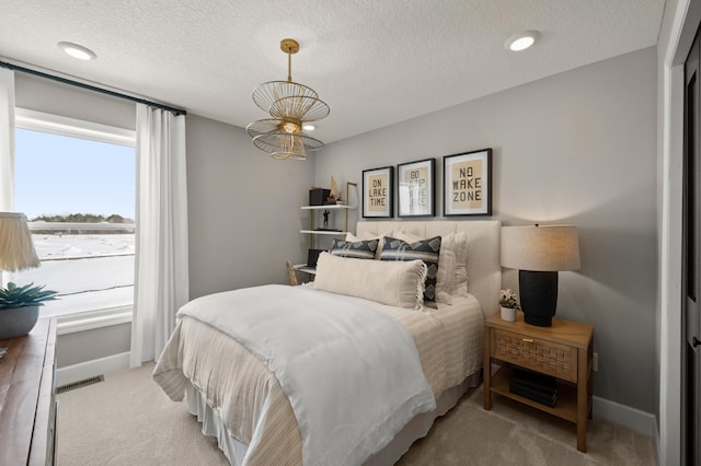 1162 Woods Creek Dr, Delano, MN 55328 - bedroom featuring light carpet, a textured ceiling, and a chandelier