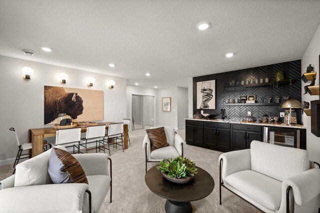 1162 Woods Creek Dr, Delano, MN 55328 - living room featuring wet bar, beverage cooler, recessed lighting, light colored carpet, and a textured ceiling