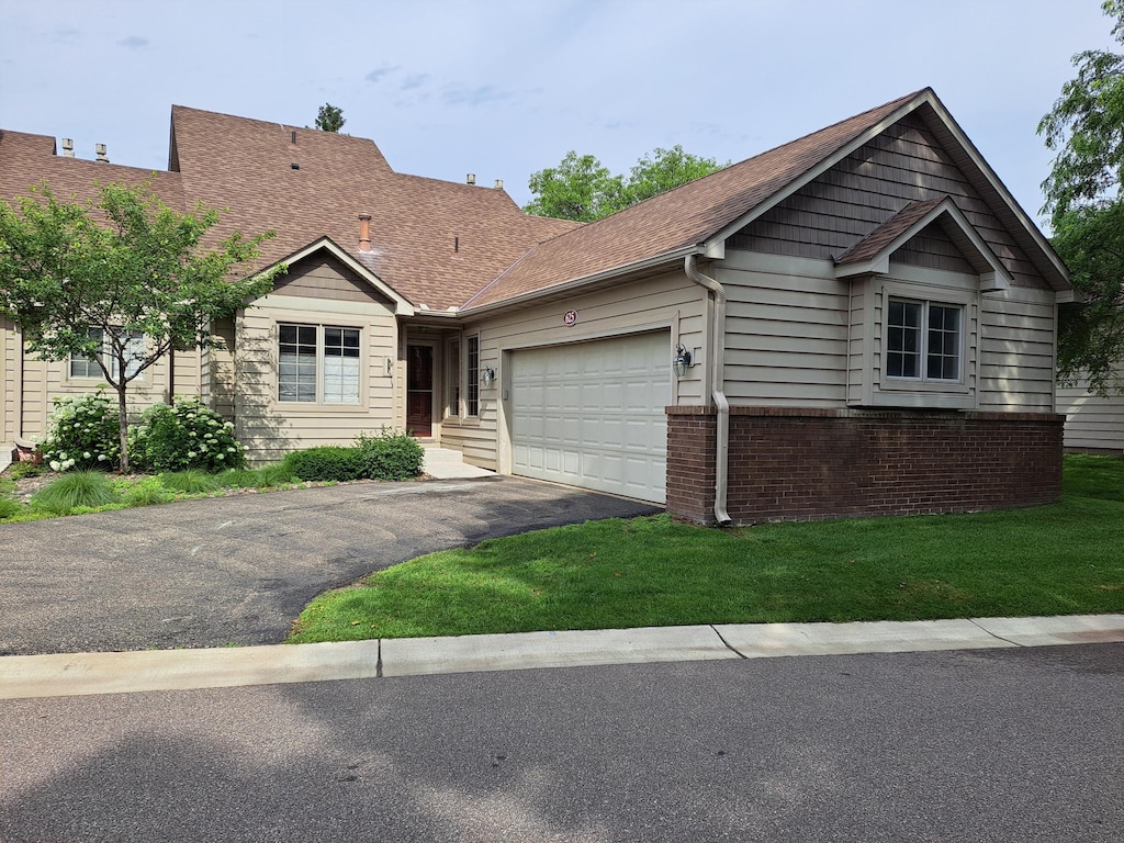 625 Sullivan Dr NE, Columbia Heights, MN 55421 - ranch-style house featuring an attached garage, driveway, a shingled roof, and a front yard