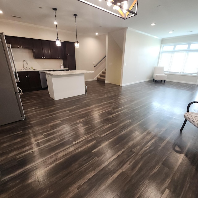 2238 Rolling Green Trl, North Mankato, MN 56003 - kitchen featuring appliances with stainless steel finishes, crown molding, open floor plan, a kitchen island, and light countertops