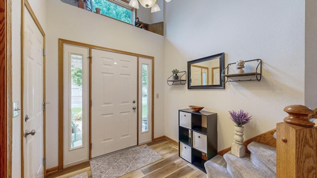1057 John And Mary Dr SE, Chatfield, MN 55923 - entrance foyer with healthy amount of natural light, light wood-style floors, stairway, and a chandelier