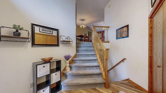 1057 John And Mary Dr SE, Chatfield, MN 55923 - staircase featuring wood finished floors and a chandelier