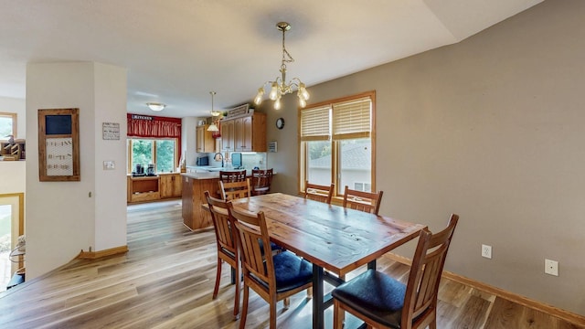 1057 John And Mary Dr SE, Chatfield, MN 55923 - dining space featuring light wood-type flooring and a chandelier