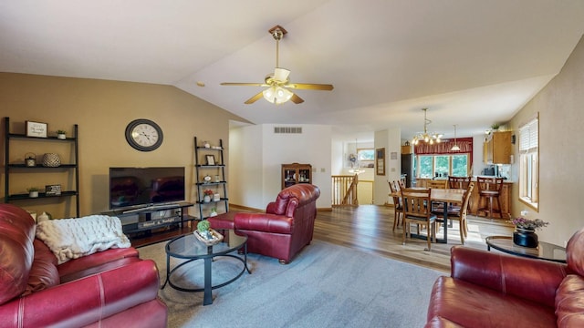1057 John And Mary Dr SE, Chatfield, MN 55923 - living room featuring a chandelier, ceiling fan, wood finished floors, and lofted ceiling