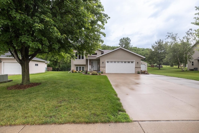 1057 John And Mary Dr SE, Chatfield, MN 55923 - tri-level home with an attached garage, concrete driveway, a front yard, and stone siding